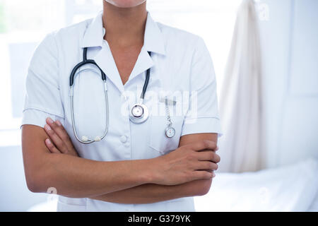 La mi-section de female doctor standing with arms crossed Banque D'Images