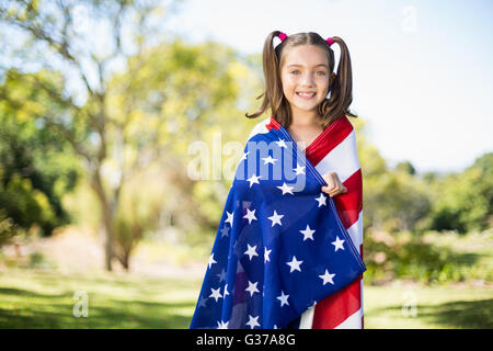 Jeune fille enveloppée de drapeau américain Banque D'Images