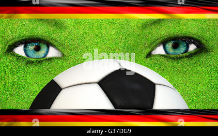 Le visage avec de l'herbe la texture et drapeaux allemands Banque D'Images