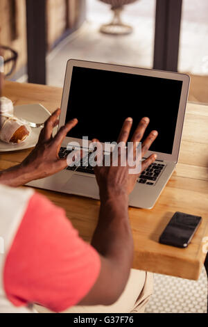 Vue arrière du hipster man using laptop Banque D'Images