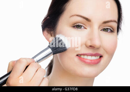 Gorgeous Woman applying makeup Banque D'Images