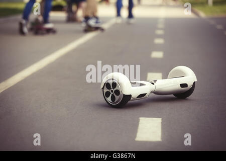 Mini électrique blanc hover board scooter sur route au parc. Eco city transportation sur batterie, ne produisent pas de pollution de l'air à l'atmosphère Banque D'Images