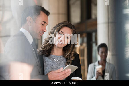 Corporate businessman and businesswoman using digital tablet Banque D'Images