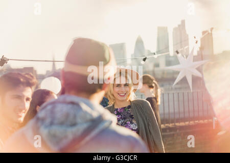 Young adult woman enjoying rooftop party Banque D'Images