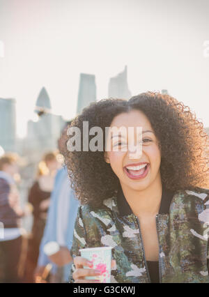 Riant Portrait young woman drinking at party Banque D'Images