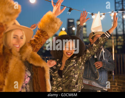 Young adult friends dancing et profiter de rooftop party Banque D'Images