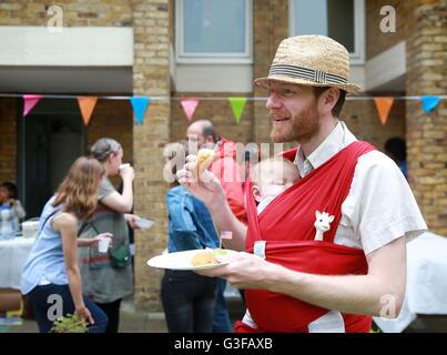 EDITORIAL N'UTILISEZ QUE Siméon et Casper Bennett (fils), qui sont résidents sur le Lockner Estate à Hackney, Londres, inscrivez-vous ensemble pour l&ECIRC;grand déjeuner qui est un événement annuel à sa huitième année qui encourage des millions de personnes dans le Royaume-Uni à se réunir avec leurs voisins pour bâtir l'esprit communautaire ce weekend. Banque D'Images