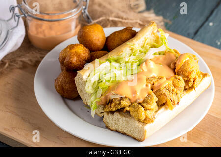 Garçon Po crevettes Sandwich avec Hush Puppies Banque D'Images