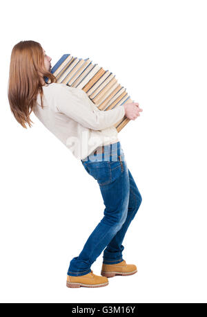 Une fille porte une lourde pile de livres. Vue de dos. Vue arrière Vue arrière. collection les gens de personne. Plus isolé sur fond blanc. Banque D'Images