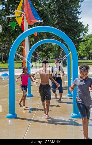 Detroit, Michigan - Les enfants courir à travers l'eau à la splash park à Palmer Park. Banque D'Images