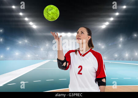 Image composite de la sportive posing with ball Banque D'Images