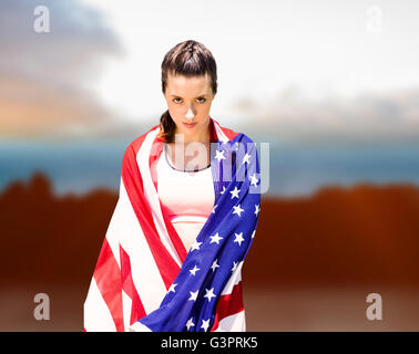 Composite image of sporty woman holding american flag Banque D'Images