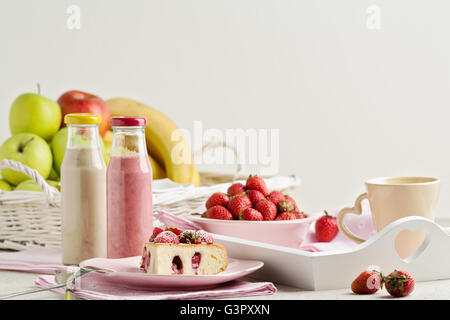 Le petit-déjeuner. Gâteau aux fraises et du café, des fruits et des baies fraise et banane smoothies. Focus sélectif. Banque D'Images