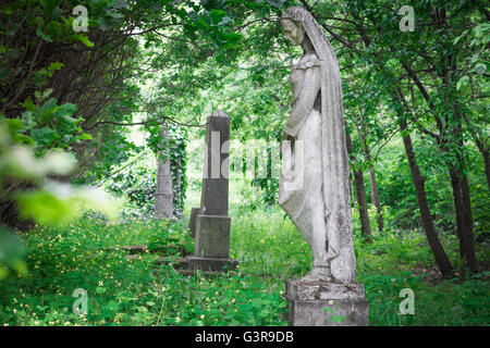Tombe de statue de femme, vue sur les monuments dans un coin oublié du cimetière de Kerepesi dans la région de Jozsefvaros à Budapest, Europe. Banque D'Images