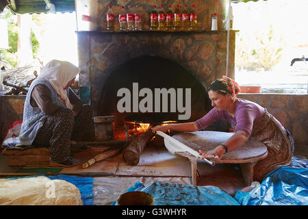 Une femme turque faire des crêpes pour les touristes dans un four traditionnel. Banque D'Images