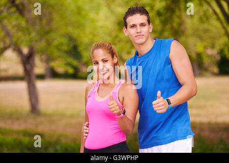 Des jeunes faisant du sport, fille et ami d'exécution, l'homme et la femme en utilisant fit watch. Concept de loisirs, santé, recreat Banque D'Images