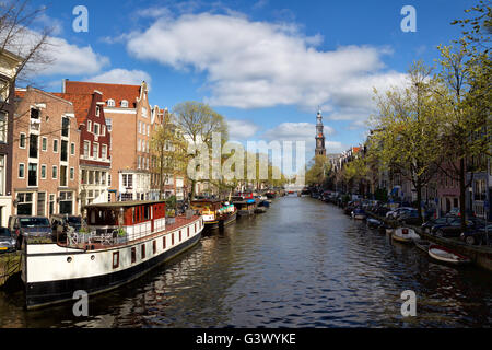 Vue le long du canal Prinsengracht vers la Westerkerk au centre-ville d'Amsterdam, Pays-Bas au printemps. Banque D'Images