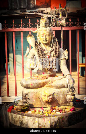 Statue de seigneur Shiva à l'adorateur de couleurs et des fleurs à Pokhara, Népal. Banque D'Images