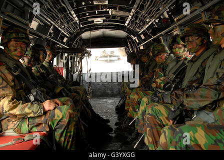 République de Corée Marines s'asseoir prêt dans un Corps des Marines américains CH-46E hélicoptère. Banque D'Images