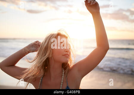 Portrait de jeune femme profitant des vacances d'été. Beau portrait modèle féminin s'amusant sur la plage. Banque D'Images