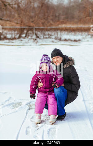 Famille heureuse mère et fille bébé fille jouer rire en hiver en plein air Banque D'Images