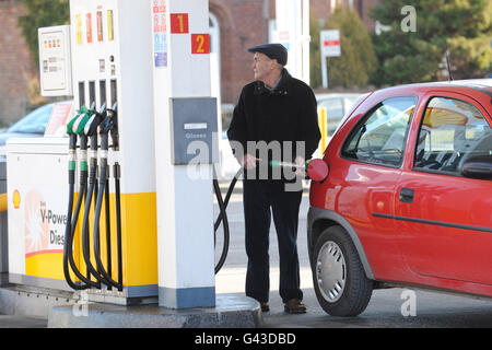 Un homme remplit sa voiture de carburant à un Station essence Shell Banque D'Images