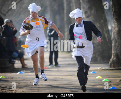 Le député travailliste Toby Perkins (à gauche) et le rédacteur politique de l'ITN Tom Bradby participent à la course parlementaire Pancake Race annuelle de Rehab UK à Westminster, Londres, pour aider à sensibiliser les gens aux dicapacités de l'organisme de bienfaisance. Banque D'Images