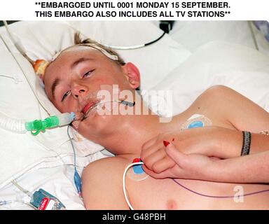 Sarah Moore tient la main de son fils Daniel Moore âgé de 12 ans, alors qu'il est gravement malade à l'hôpital aujourd'hui (dimanche) après avoir été violemment attaqué par une bande de 20 jeunes mardi (9/9/97). Daniel, a été battu au sujet de la tête avec des briques, des bouteilles cassées et des morceaux de bois dans un terrain de jeu près de sa maison à Hounslow, à l'ouest de Londres. Photo de Fiona Hanson/PA. Regardez l'histoire des PA Banque D'Images