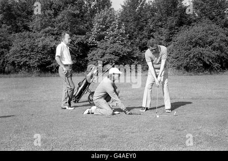 Caddy John Thornberry aide le golfeur aveugle Gerry Brereton à s'aligner pour une photo de puce sur le parcours Banque D'Images