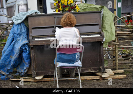 Festival de Glastonbury 2011 - samedi.Un animateur joue du piano dans la boue au festival Glastonbury à la ferme de la ville de Pilton. Banque D'Images