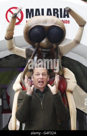 Chris Packham, présentateur de télévision et expert en faune, pose avec un moustique géant pour soutenir l'exposition Malaria Dome, organisée et financée par GlaxoSmithKline Travel Health, qui se tient au zoo de Londres ZSL du 12 au 21 août. Banque D'Images