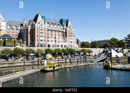 Empress Hotel, Victoria, île de Vancouver, Colombie-Britannique. Vu sur le port avec un taxi de l'eau jaune au premier plan. Banque D'Images