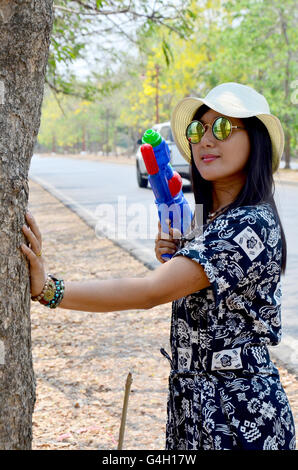 Portrait de femme thaïlandaise et canon à eau toy à attendre en plein air inscrivez-vous avec Songkran Festival est célébré dans une nouvelle année est le jour traditionnel Banque D'Images