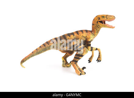 Vue côté jouet velociraptor jaune sur fond blanc Banque D'Images