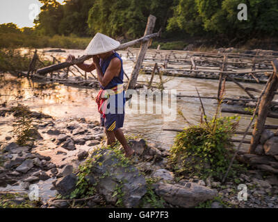 19 juin 2016 - Don Khone, Champassak, Laos - Un pêcheur porte une partie d'un de ses pièges à poissons jusqu'à la terre à soi Pa Khon Chutes d'eau, sur le côté est de Don Khon. C'est le plus petit des deux chutes d'eau en Don Khon. Les pêcheurs ont construit un système complexe de ponts de cordes au-dessus des chutes qu'ils utilisent pour se rendre à l'pièges à poissons. Les pêcheurs de la région sont aux prises avec une baisse des rendements et les petits poissons, qui menaçaient leur mode de vie. Le Mékong est l'un des plus riches et productifs fleuves sur Terre. C'est un haut lieu mondial pour les poissons d'eau douce : plus de 1 000 espèces ont été Banque D'Images