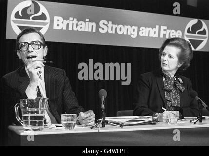 Le Premier ministre Margaret Thatcher se penche sur le discours de Norman Fowler, secrétaire des services sociaux, lors de la Conférence de presse quotidienne du Parti conservateur. Banque D'Images