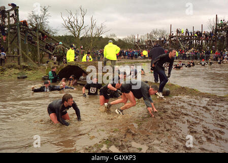 Des concurrents qui participent à la course d'endurance difficile Guy 2000 pour la charité dans le Staffordshire. Le parcours tortueux comprend un filet d'escalade électrifié, une baignade sous-marine glaciale et une reconstitution des débarquements de Dunkerque. * Michael Green, 44 ans, de Groby , près de Leicester est mort à l'hôpital après une crise cardiaque soupçonnée à la course. Il avait terminé environ les trois quarts du parcours de sept milles avant de se plaindre du froid. Banque D'Images