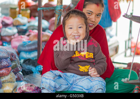 Le Népal, Région du Centre, de l'Annapurna Benighat Circuit - Katmandou à Bhulbhule - Mère avec enfant sur un marché de rue dans l'ouest de Katmandou Benighat Banque D'Images