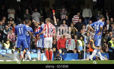 Soccer - Barclays Premier League - Chelsea / Stoke City - Stamford Bridge.Ricardo Fuller de la ville de Stoke (troisième à gauche) est envoyé par l'arbitre André Marriner pour un timbre sur Branislav Ivanovic de Chelsea (au sol) Banque D'Images