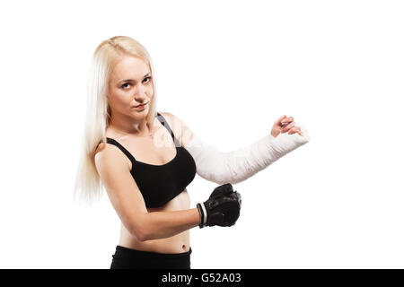 Fille blonde de remise en forme avec un bras cassé dans le plâtre, pose de boxe Banque D'Images