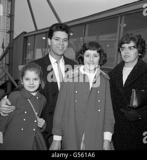 Le chanteur de pop Cliff Richard avec ses sœurs Joan, 10 ans, à gauche, et Jacqueline, 13 ans, Et mère, Dorothy Webb, à l'aéroport d'Heathrow, avant d'embarquer dans un avion pour l'Espagne où ils passent les vacances de Noël. Banque D'Images