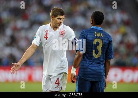 Football - UEFA Euro 2012 - Groupe D - Angleterre / France - Donbass Arena.Patrice Evra (à droite) en France et Steven Gerrard en Angleterre s'étrardent pendant le match Banque D'Images