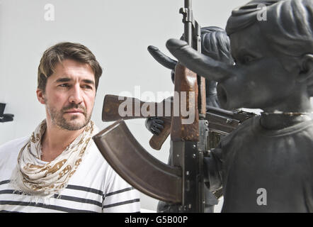 Son Symondson, photographe et ex-soldat, avec un travail en cours, une pièce de Jake Chapman qui sera mise aux enchères avec tous les bénéfices de la campagne Peace One Day, au studio de Jake Champman à Londres. Banque D'Images