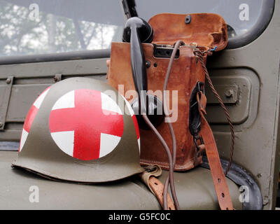 WW2 US Army medecins casque d'acier et d'un téléphone de campagne sur le capot d'une jeep des années 1940. Banque D'Images