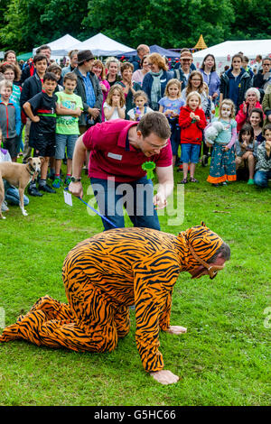 Un homme habillé en costume de tigre prend part à une exposition canine, Kingston Fête du Village, Lewes, dans le Sussex, UK Banque D'Images