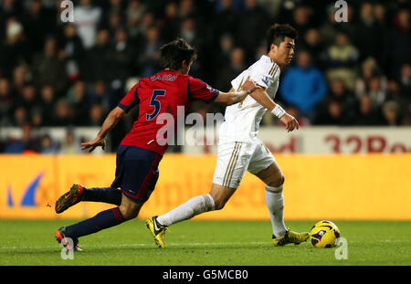 Ki Sung-Yueng, de Swansea, s'éloigne de Claudio Yacob (à gauche) de West Bromm lors du match de la Barclays Premier League au Liberty Stadium, à Swansea. Banque D'Images