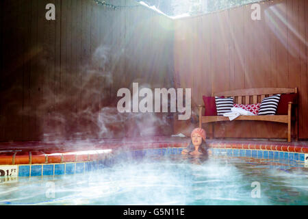 Woman relaxing in jacuzzi Banque D'Images