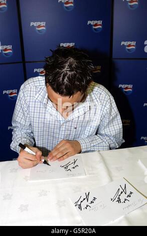 Gareth Gates, finaliste pop Idol, signe des autographes pour les fans lors d'une séance de rencontre avec les Pepsi, lors de la visite en direct des finalistes pop Idol, à l'arène de Londres à Docklands. Banque D'Images