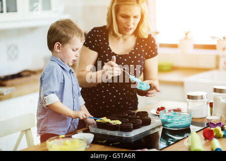 La mère et l'enfant heureux dans la cuisine préparer les cookies Banque D'Images