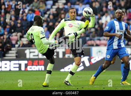 Papiss Cisse de Newcastle United (à gauche) et James Perch sont présents les uns les autres essaient d'avoir un coup de feu sur le but Banque D'Images